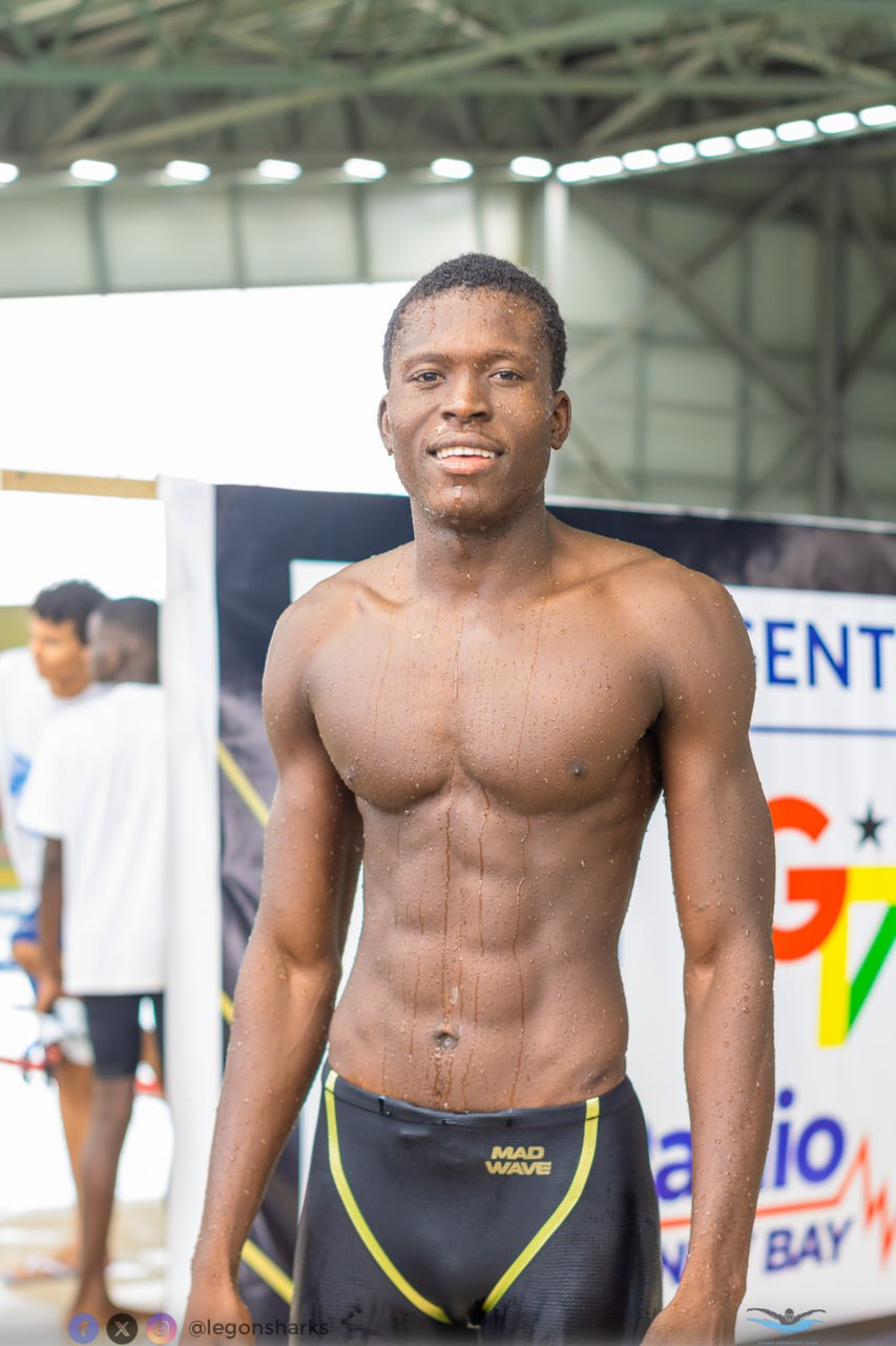Young adult male swimmer smiling post-race Mad Wave jammers
