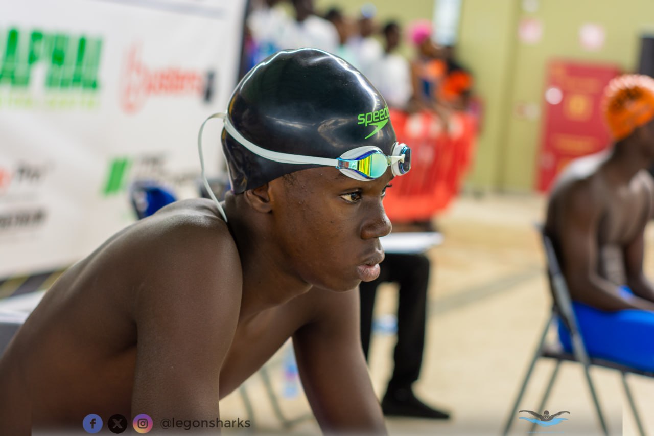 Young male swimmer in Speedo cap intense pre-race focus