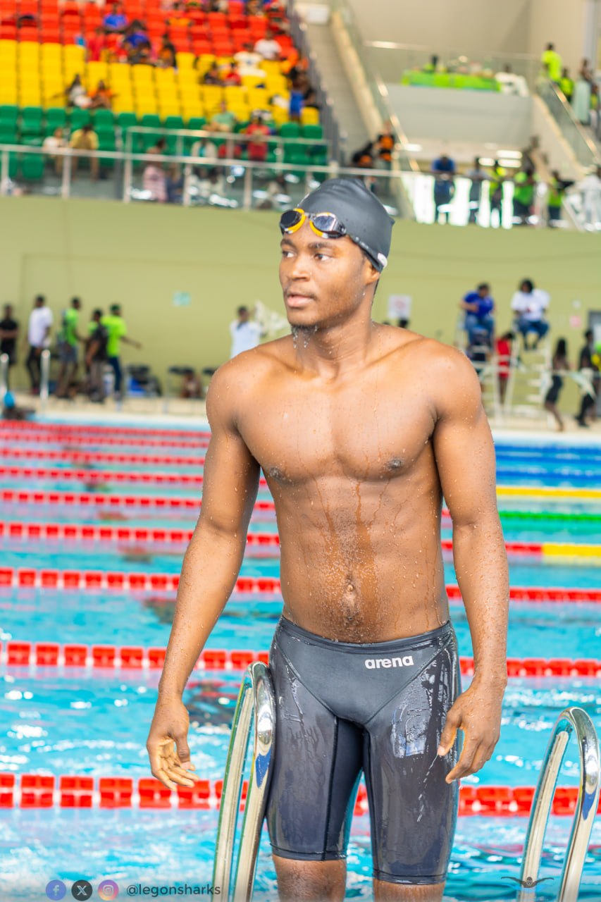 Young male swimmer in Arena jammers poolside wide competition venue