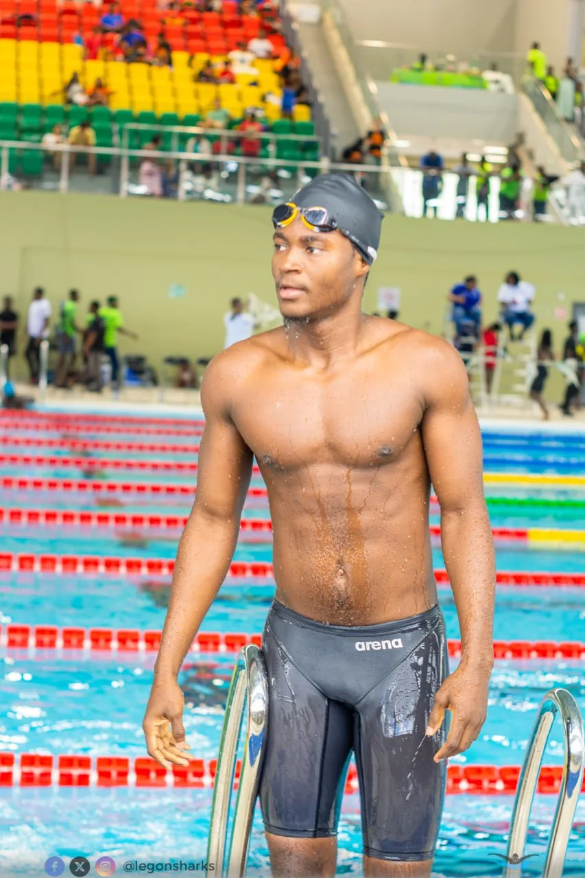 Young male swimmer in Arena jammers poolside wide competition venue