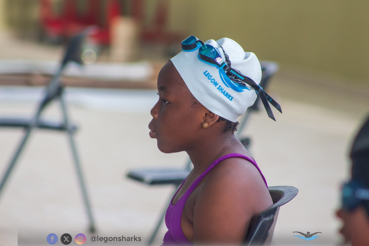 Young female Legon Sharks swimmer in profile pre-race white cap