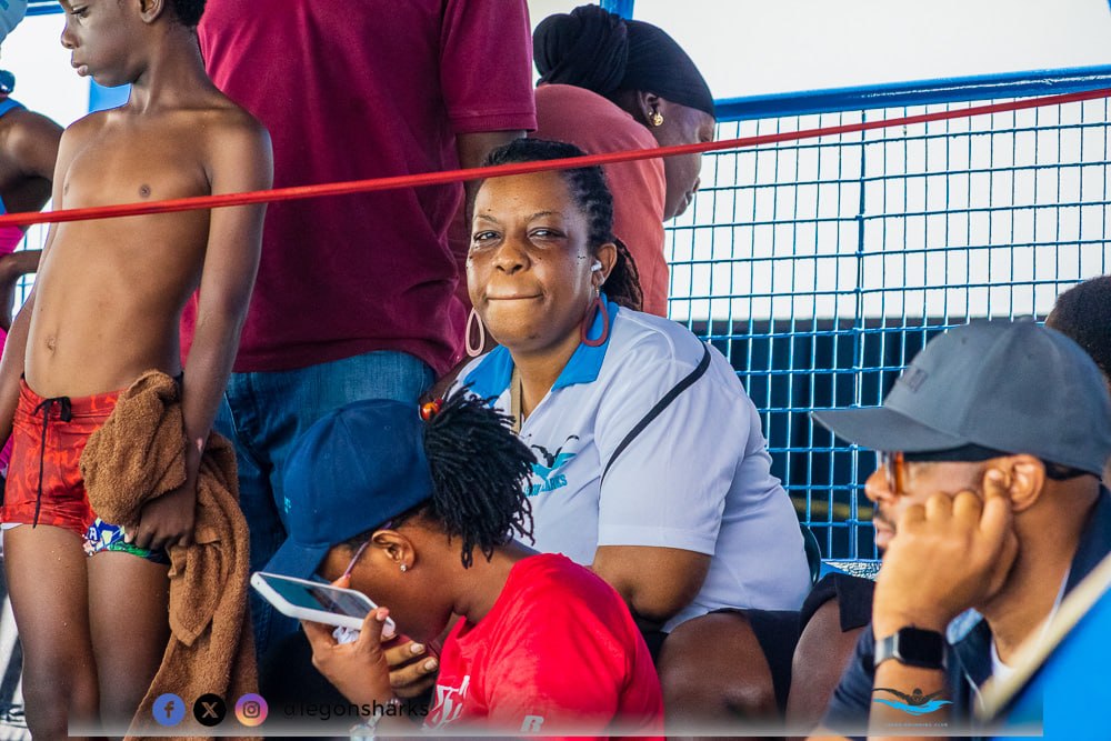 Legon Sharks club member smiling in the stands at a swim meet