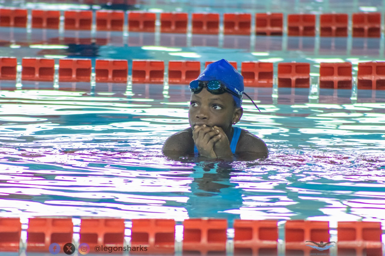 Young swimmer at the pool wall