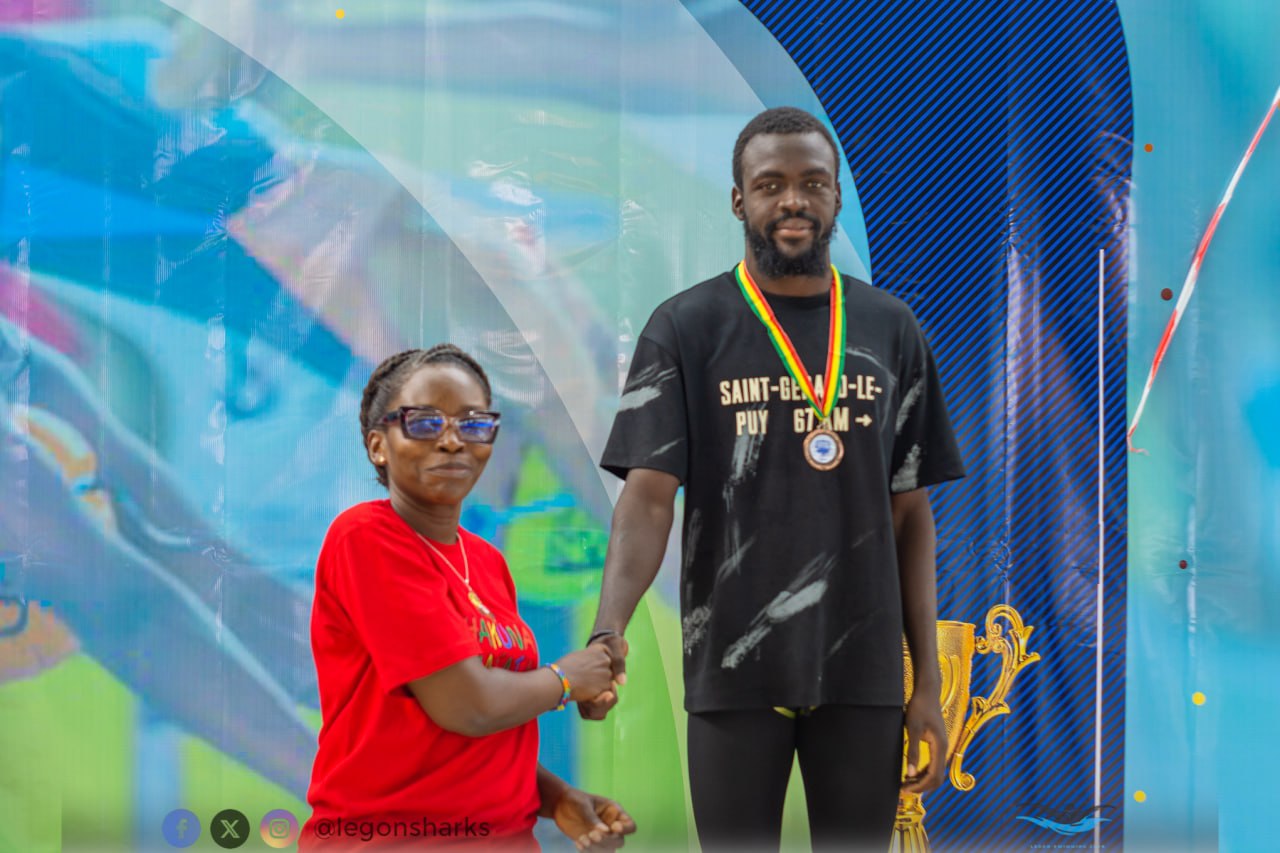 Swimmer receiving trophy and medal