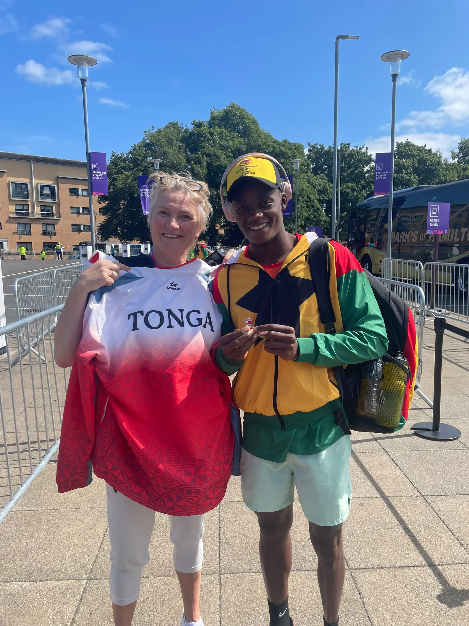 Promise Aheto with a Commonwealth Games attendee holding Tonga team clothing at Glasgow 2026